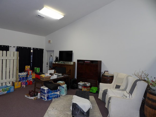 living room with lofted ceiling, visible vents, and carpet floors