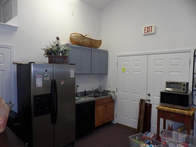 kitchen featuring a toaster, light countertops, stainless steel appliances, gray cabinetry, and a sink