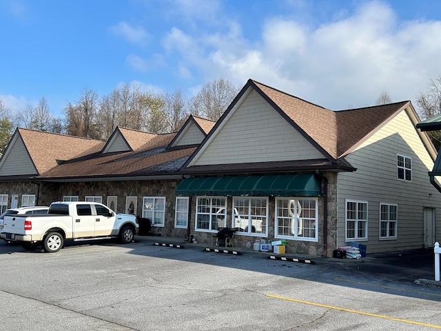 view of property featuring uncovered parking