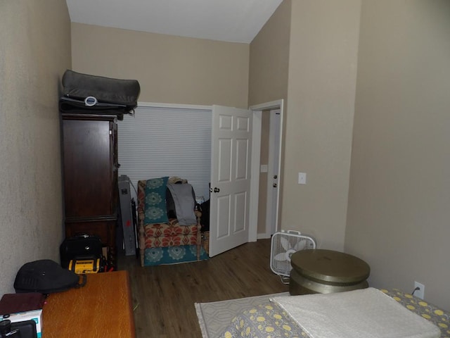 bedroom with dark wood-type flooring