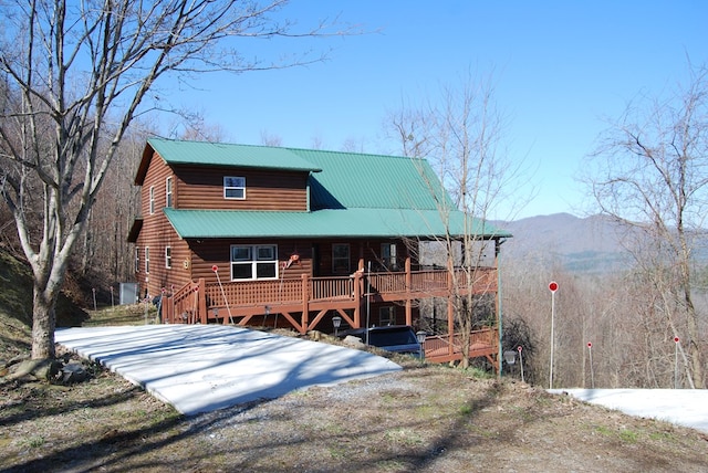 log home featuring metal roof and a porch