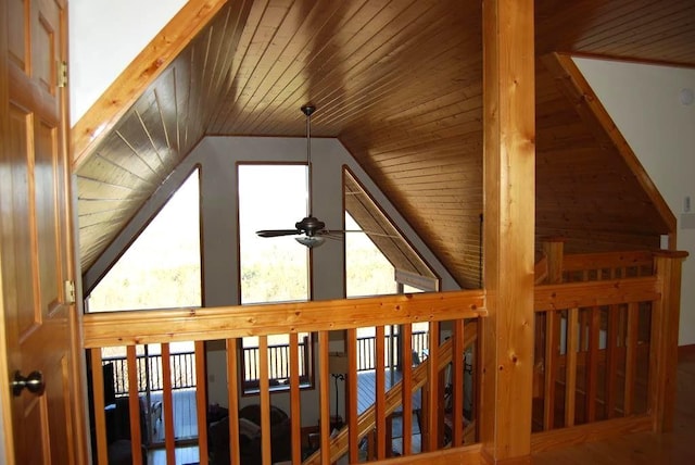 staircase featuring lofted ceiling, a ceiling fan, and wooden ceiling