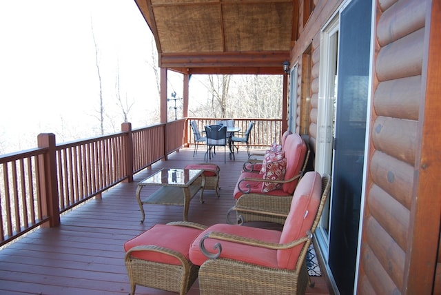 wooden terrace with outdoor dining space