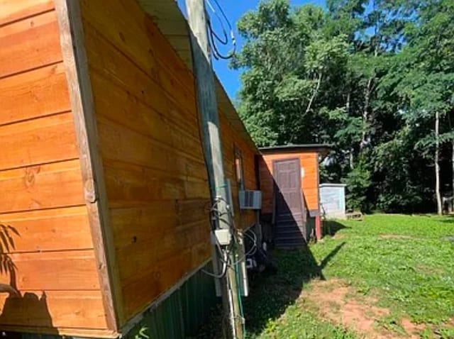 view of side of home with a lawn