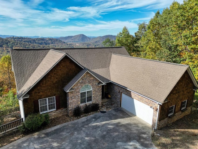 view of front facade with a mountain view and a garage