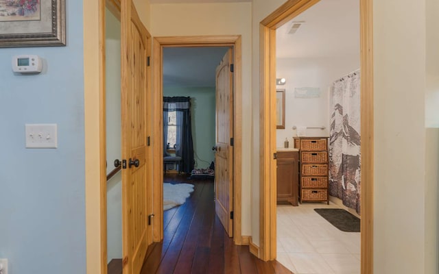 hallway with hardwood / wood-style flooring