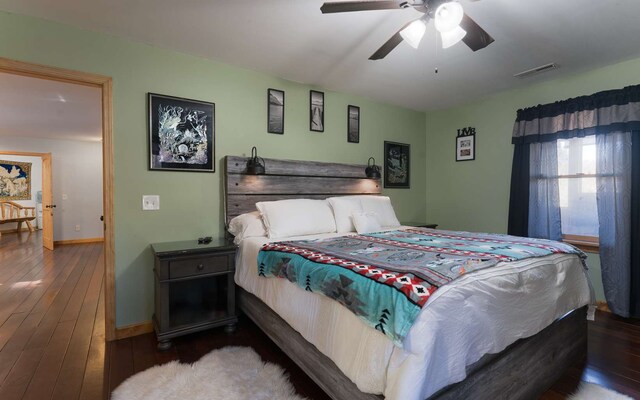 bedroom with ceiling fan and dark hardwood / wood-style flooring