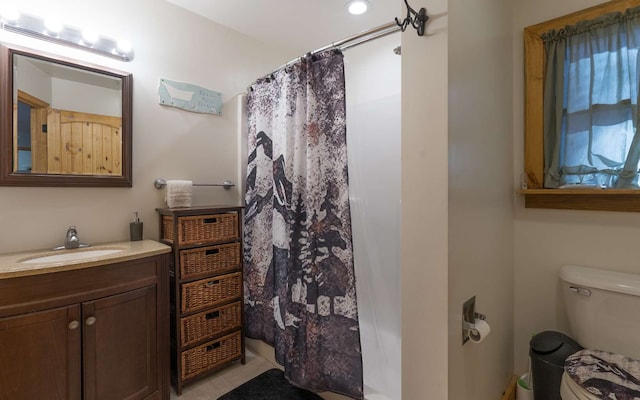 bathroom featuring vanity, toilet, and tile patterned floors