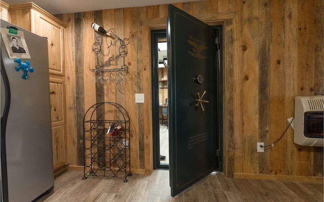 interior space featuring light hardwood / wood-style flooring and wooden walls