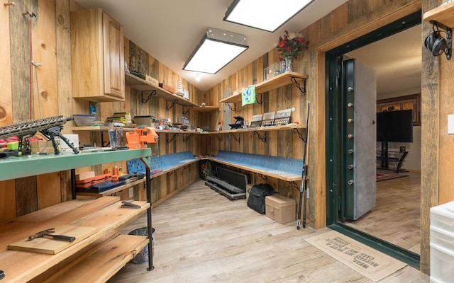 kitchen with wood walls and light wood-type flooring