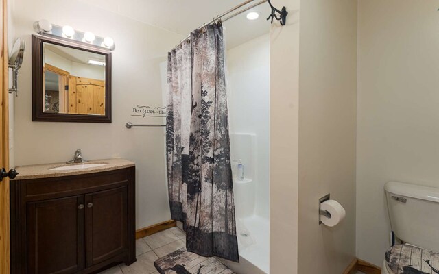 bathroom with vanity, toilet, and tile patterned floors