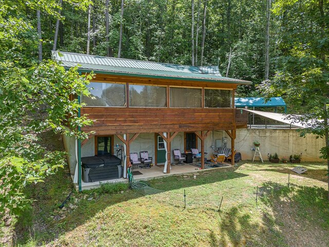 rear view of property featuring a patio area and a yard