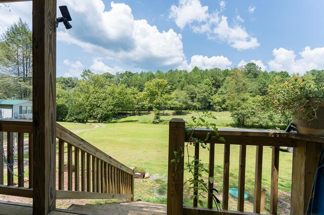 wooden deck featuring a yard