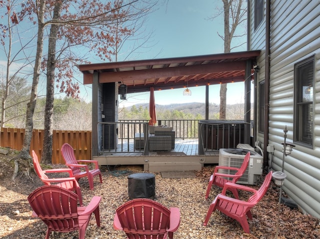 wooden terrace featuring fence and central AC