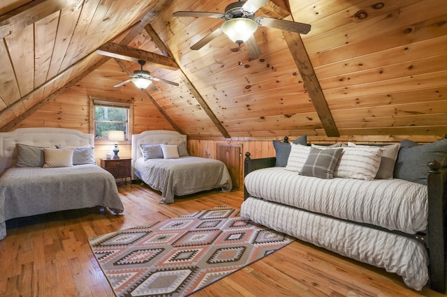 bedroom with hardwood / wood-style flooring, lofted ceiling with beams, wood walls, and wood ceiling