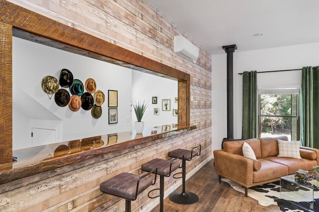 bar with hardwood / wood-style floors and brick wall