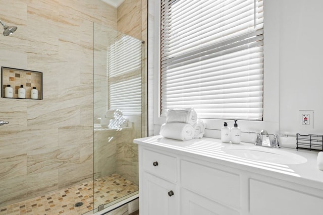 bathroom with vanity and a shower with door