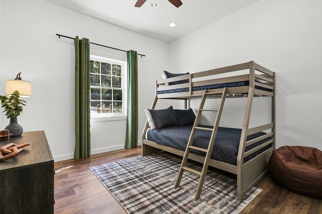 bedroom with ceiling fan and dark wood-type flooring