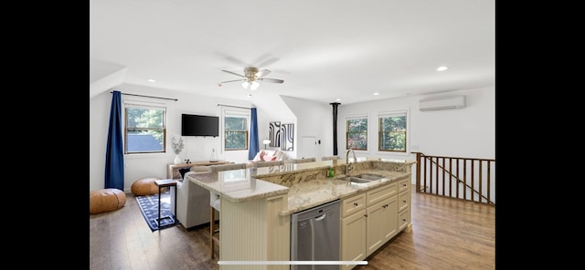 kitchen featuring a wall mounted air conditioner, dishwasher, a kitchen island with sink, dark wood-type flooring, and sink