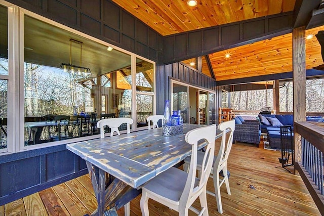 sunroom / solarium with wooden ceiling, vaulted ceiling, and an inviting chandelier