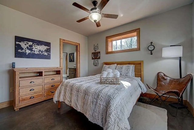 bedroom with ceiling fan, concrete floors, ensuite bath, and baseboards