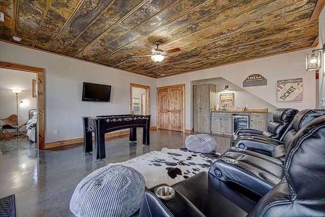 living room featuring wine cooler, a dry bar, finished concrete floors, wooden ceiling, and baseboards