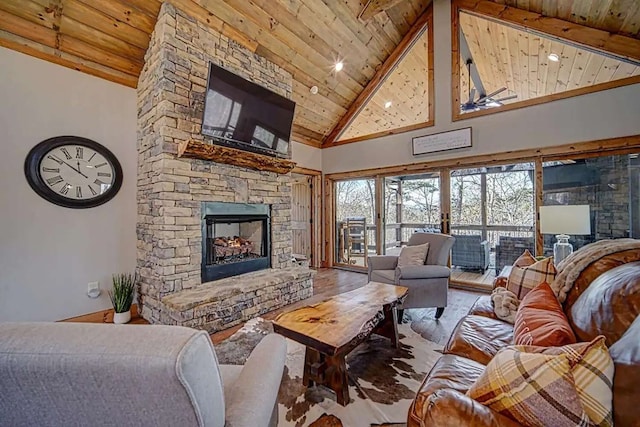 living room featuring wood ceiling, a fireplace, high vaulted ceiling, and beamed ceiling