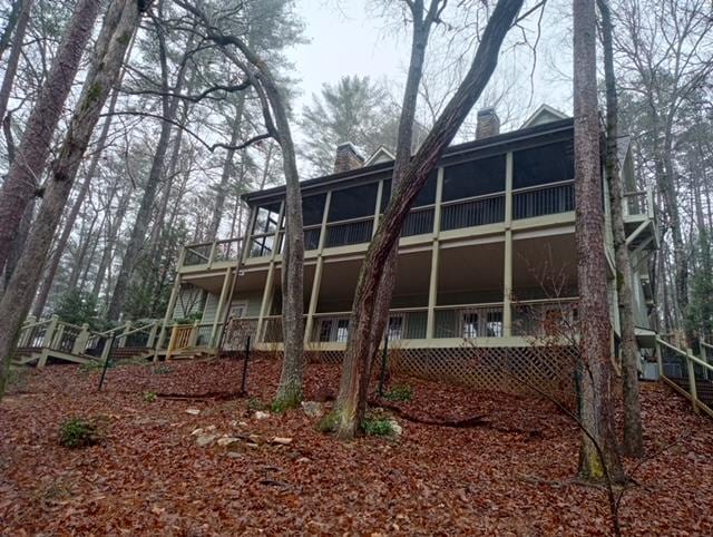 back of property with a sunroom