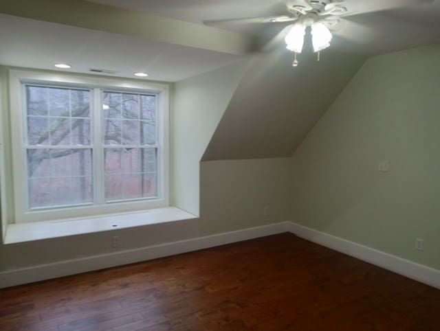 additional living space with hardwood / wood-style floors, vaulted ceiling, and ceiling fan