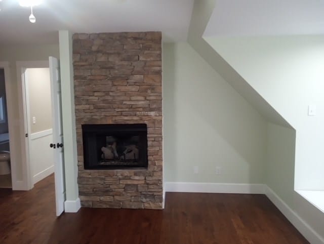 interior space with a fireplace and dark wood-type flooring