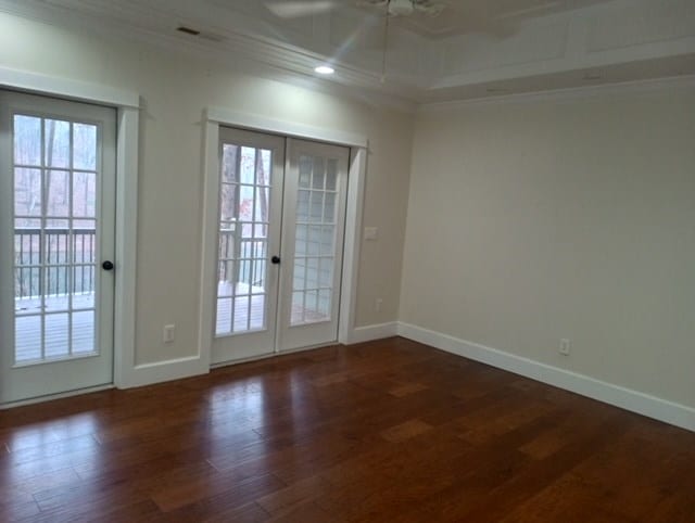 doorway with french doors, crown molding, and dark hardwood / wood-style flooring