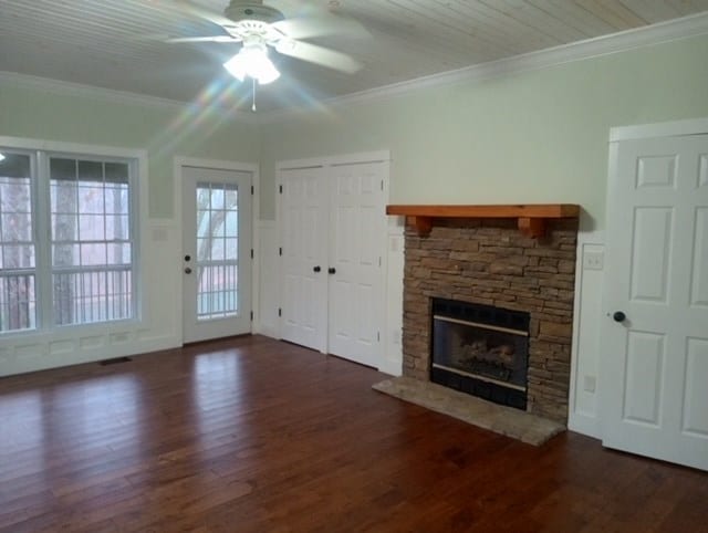 unfurnished living room featuring ceiling fan, dark hardwood / wood-style flooring, and ornamental molding