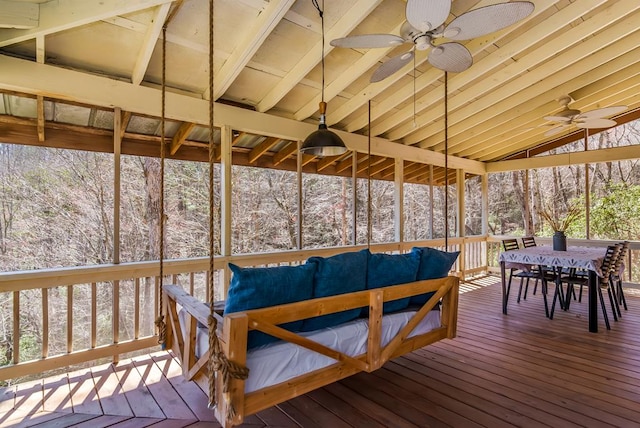 wooden terrace with ceiling fan, outdoor dining space, and an outdoor hangout area