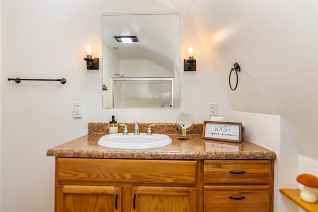 full bathroom featuring lofted ceiling, vanity, and an enclosed shower