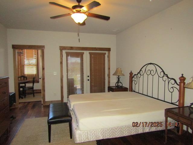 bedroom with ceiling fan and dark wood-type flooring