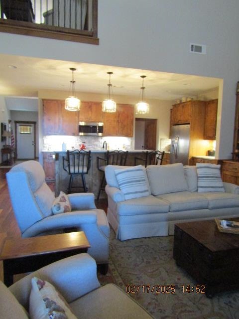 living room featuring a towering ceiling