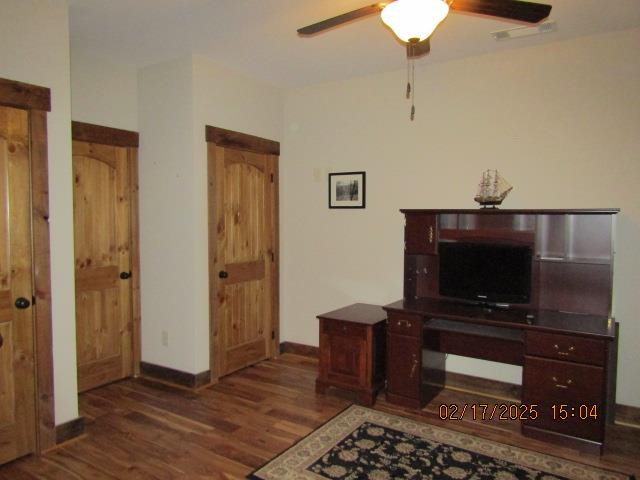 office with ceiling fan and dark hardwood / wood-style floors