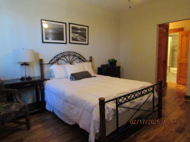 bedroom with dark wood-type flooring