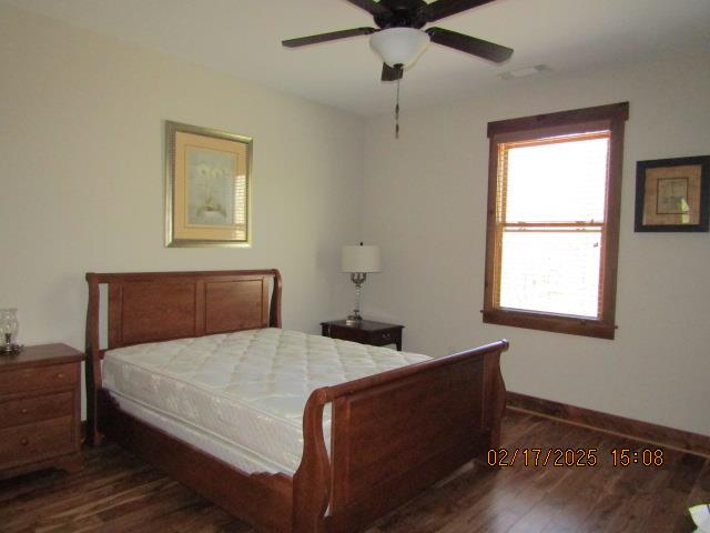 bedroom featuring ceiling fan and dark hardwood / wood-style flooring