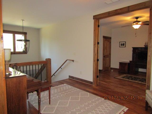 stairs with ceiling fan and wood-type flooring