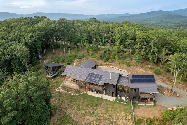 aerial view featuring a mountain view and a wooded view