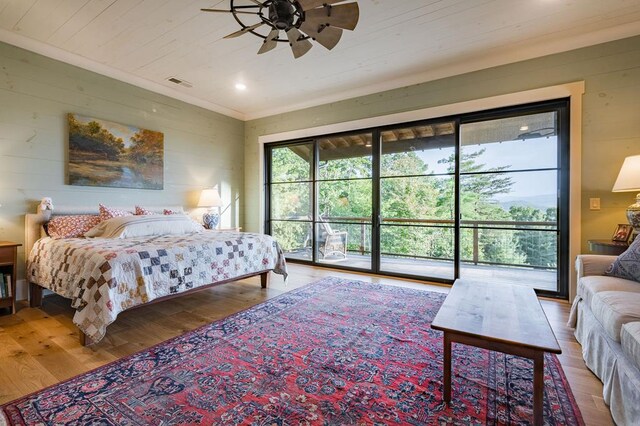 bedroom with access to exterior, visible vents, wooden walls, wood ceiling, and wood finished floors