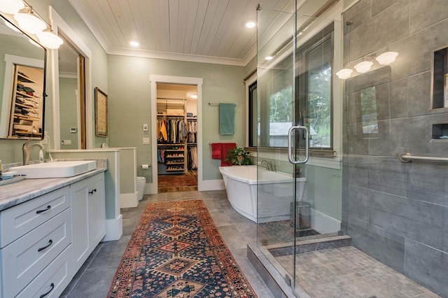 bathroom featuring vanity, a soaking tub, a shower stall, a spacious closet, and crown molding