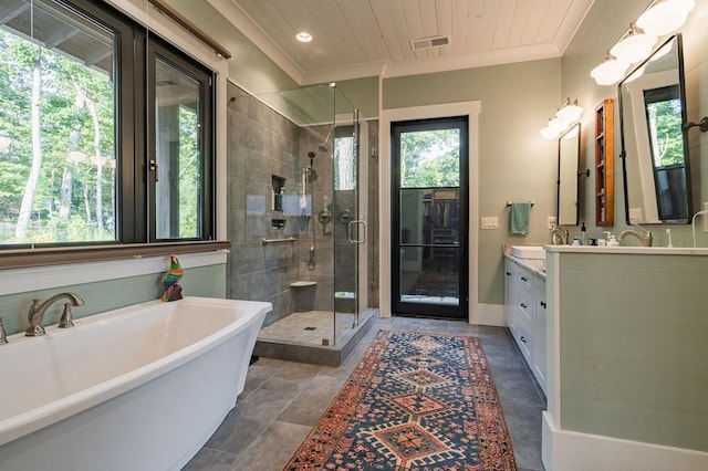 bathroom featuring visible vents, ornamental molding, a stall shower, a soaking tub, and vanity