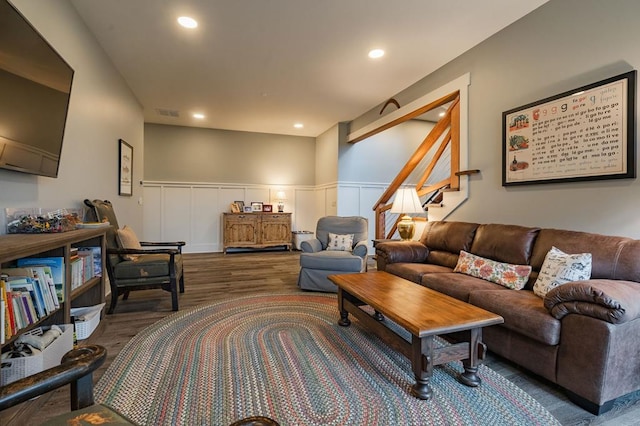 living room featuring recessed lighting, wainscoting, stairs, and wood finished floors