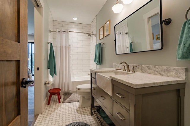 bathroom featuring vanity, toilet, and shower / bath combo