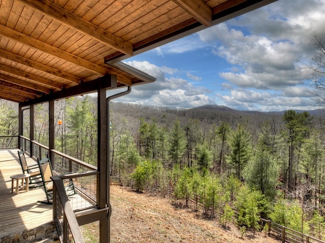 exterior space featuring a wooded view