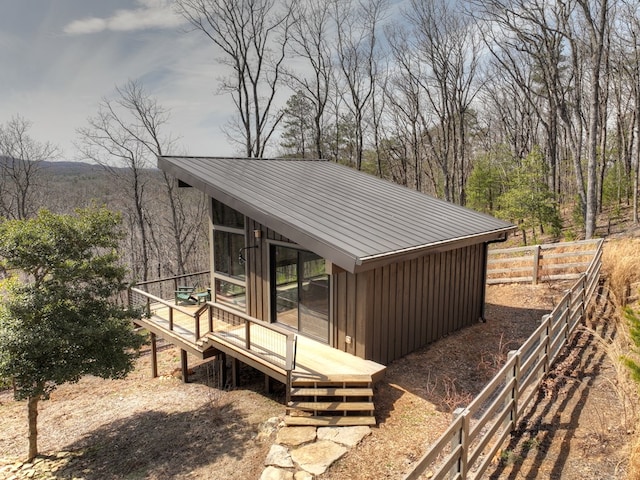 view of outbuilding featuring fence