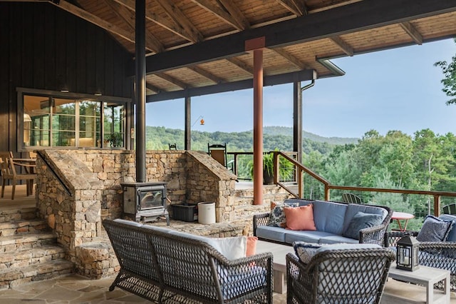 view of patio featuring an outdoor living space and a wooded view