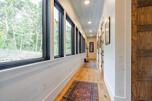 hall featuring recessed lighting, light wood-type flooring, and baseboards